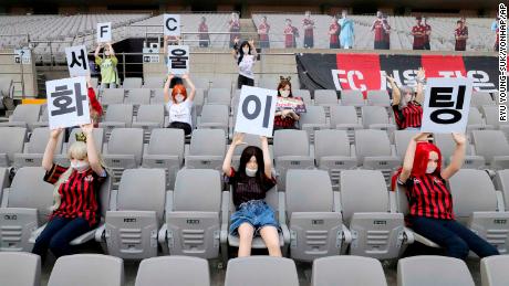 In this May 17, 2020 photo, Cheering mannequins are installed at the empty spectators' seats before the start of soccer match between FC Seoul and Gwangju FC at the Seoul World Cup Stadium in Seoul, South Korea. A South Korean professional soccer club has apologized after being accused of putting sex dolls in empty stands during a match Sunday in Seoul. In a statement, FC Seoul expressed "sincere remorse" over the controversy, but insisted that it used mannequins, not sex dolls, to mimic a home crowd during its 1-0 win over Gwangju FC at the Seoul World Cup stadium. The signs read " Go! FC Seoul." (Ryu Young-suk/Yonhap via AP)